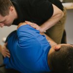 A-chiropractor-performing-a-chiropractic-alignment-on-a-patient-with-low-back-pain-1030x687